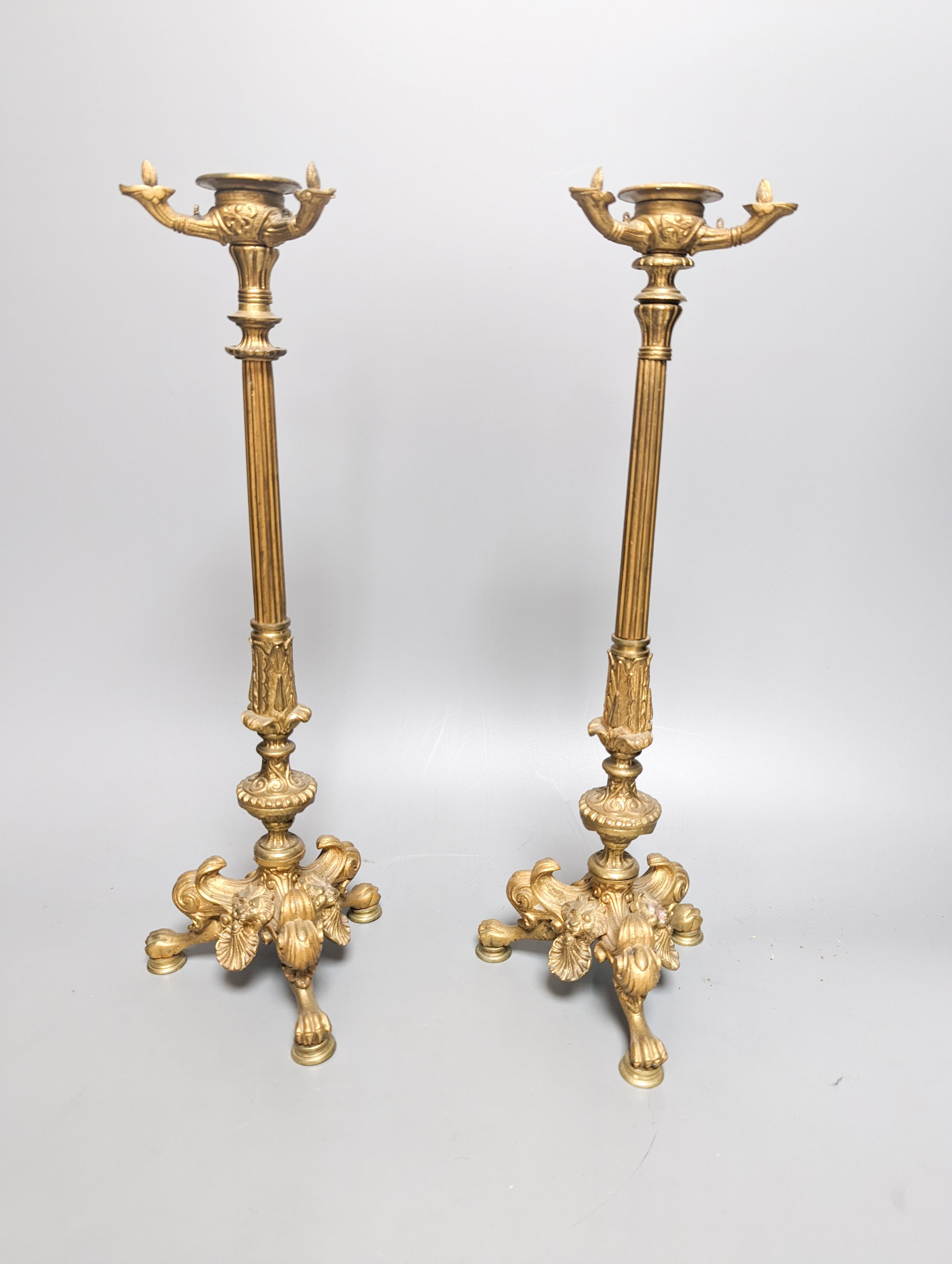 A pair of Empire style ormolu candlesticks and a pair of fire irons tallest 36cm